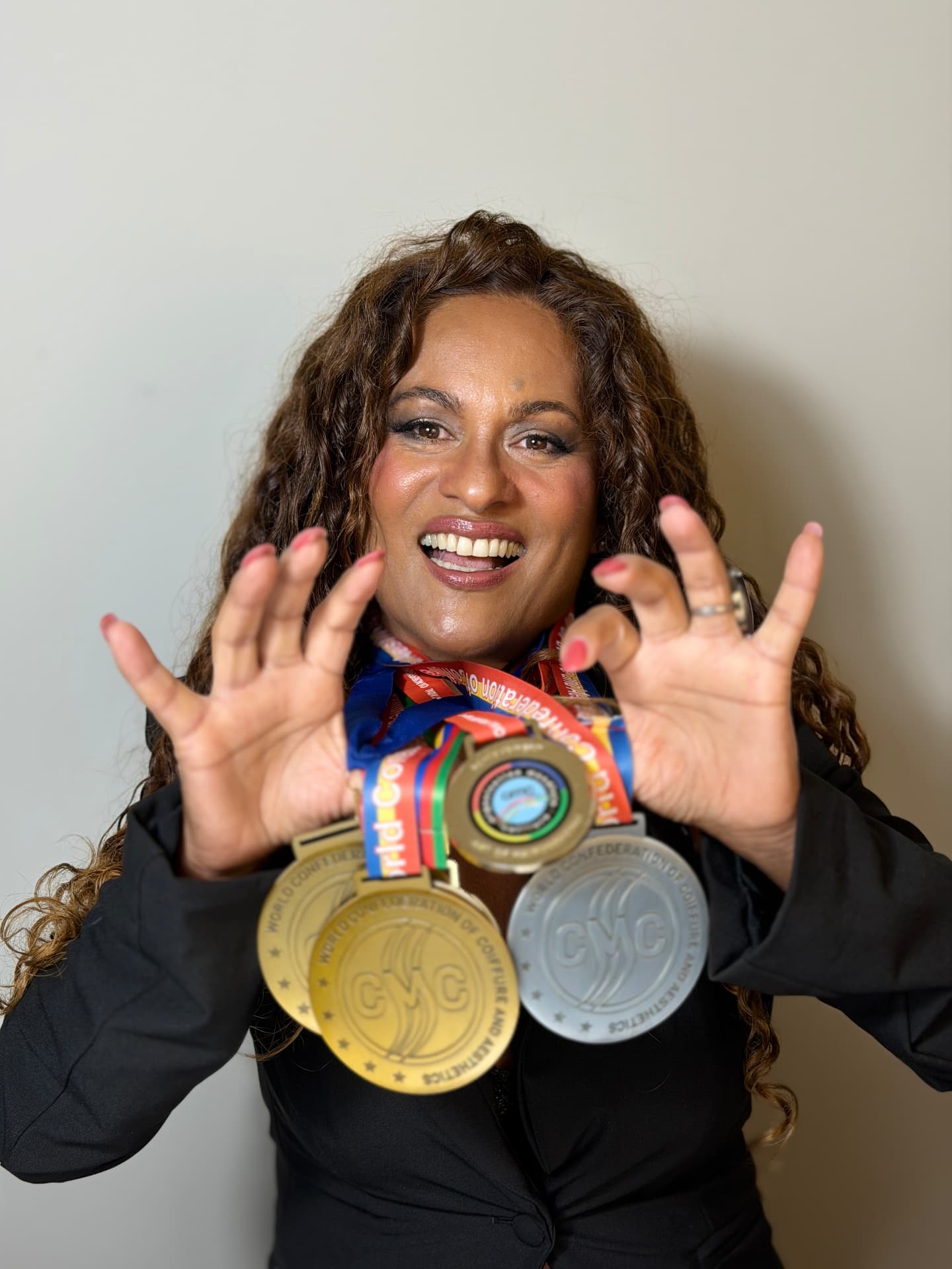 Nanci Cardoso celebrating with championship medals